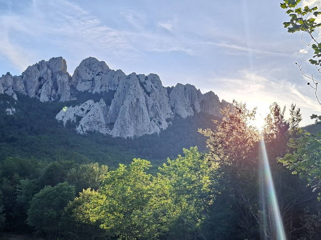 Jagged limestone peaks of Velebit rising above the forest