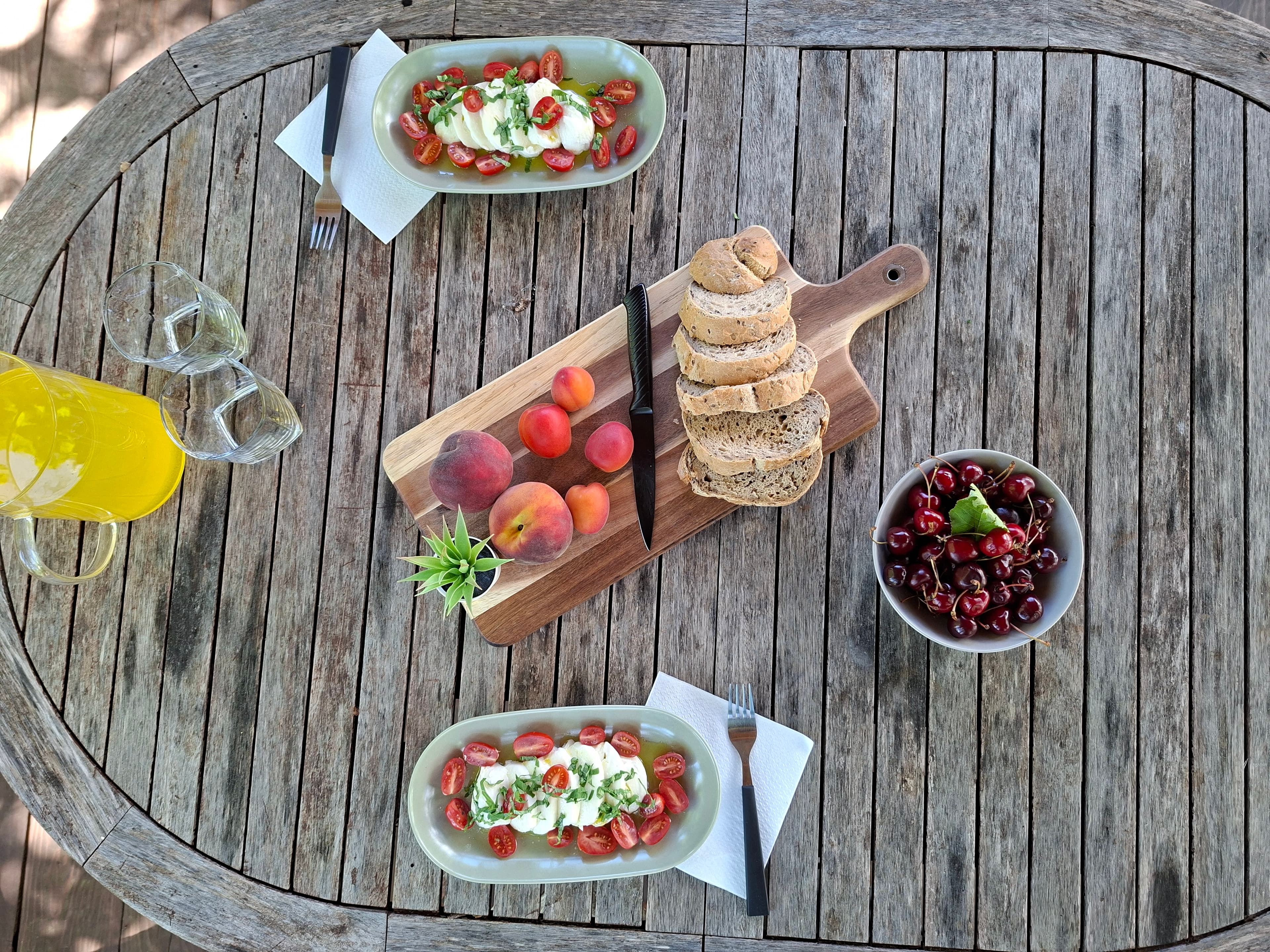 Outdoor table set for lunch under the trees at Stars Peak