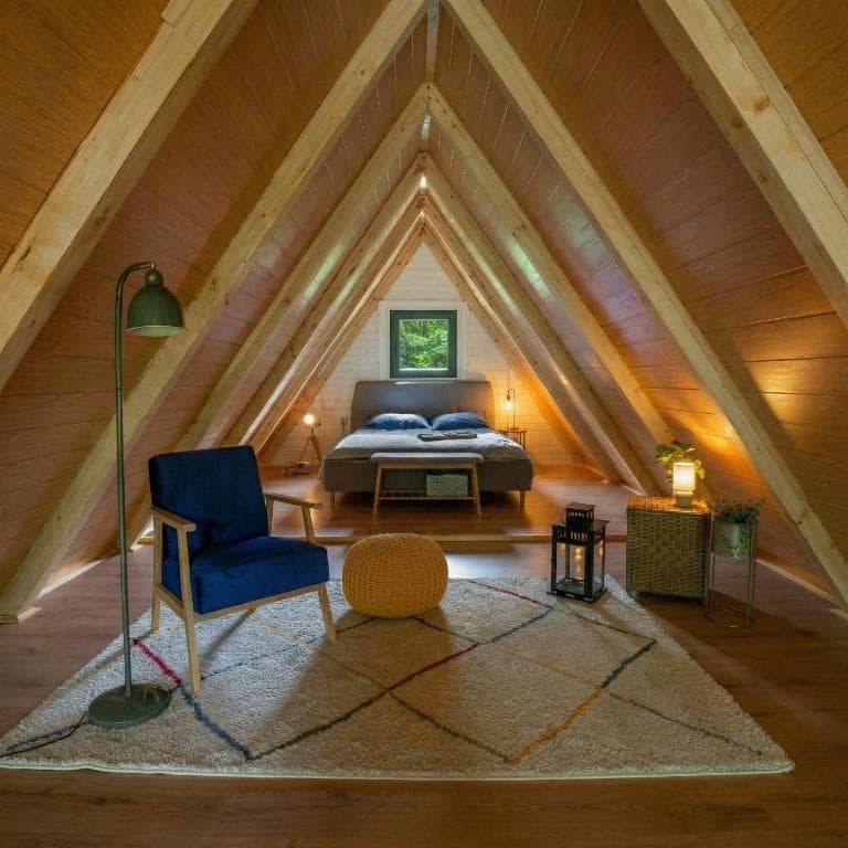 A-frame loft bedroom and sitting area seen from a distance